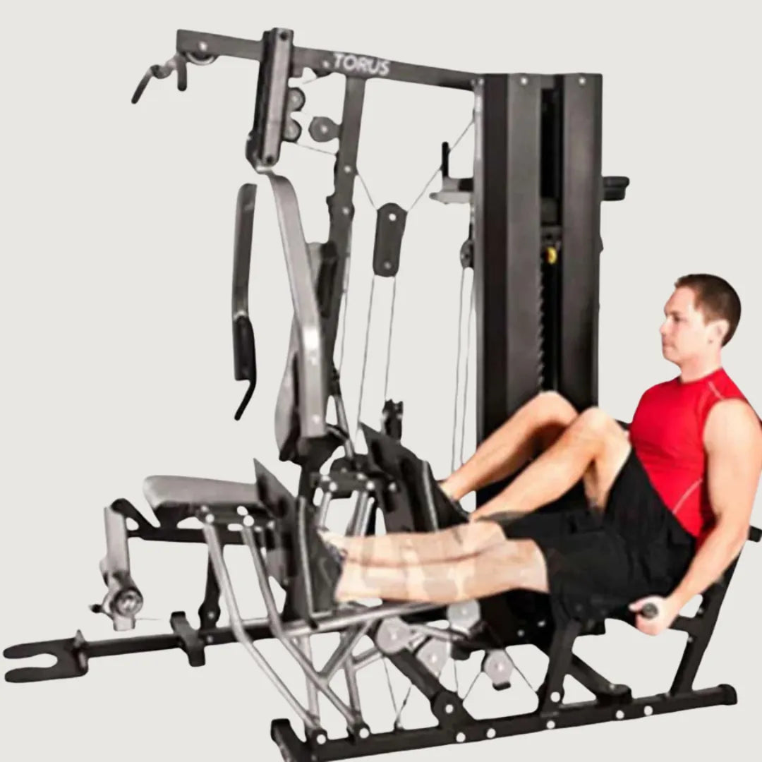 Man performing leg press exercises on the seated leg press attachment of the multi-gym machine.