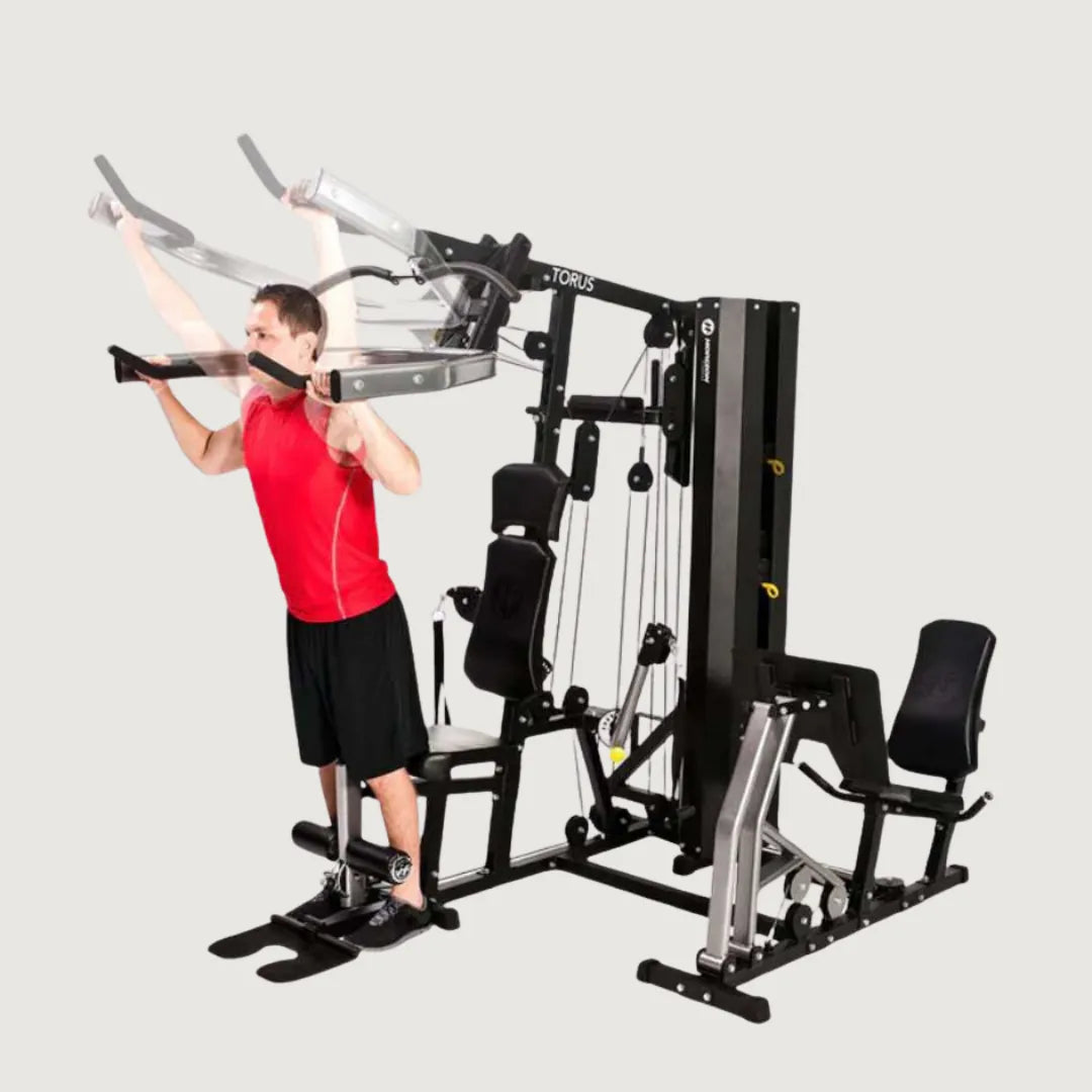  Man performing weighted squats using the shoulder press station of the multi-gym machine.