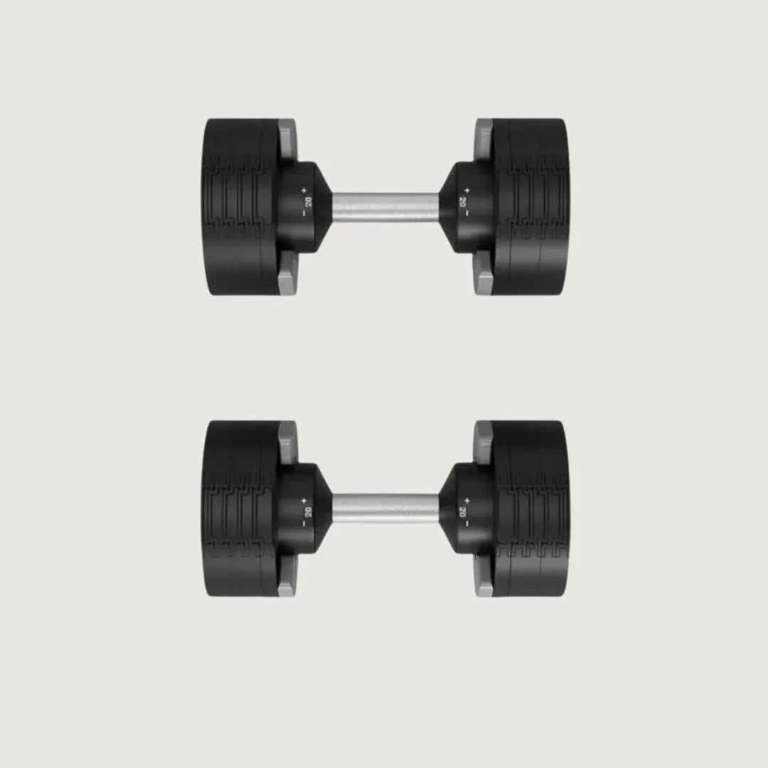 Top-down view of two adjustable dumbbells showing weight indicators and knurled handles.