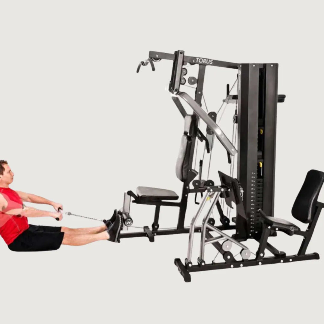 Man performing leg press exercises on the seated leg press attachment of the multi-gym machine.