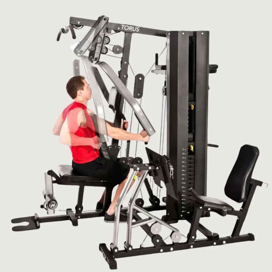 Man using the cable crossover feature of the multi-gym machine for chest and arm exercises