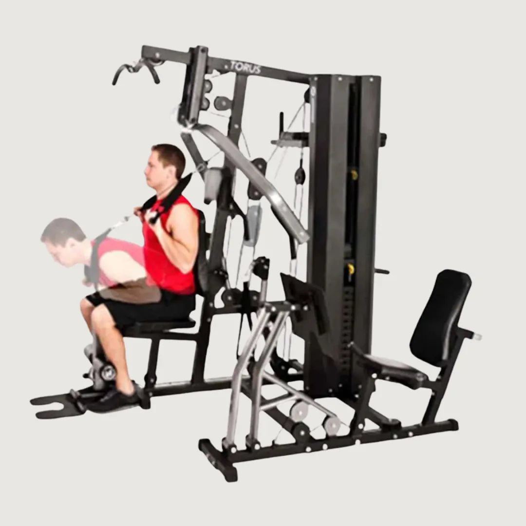 Man performing seated cable row exercise using the low pulley on the multi-gym machine.