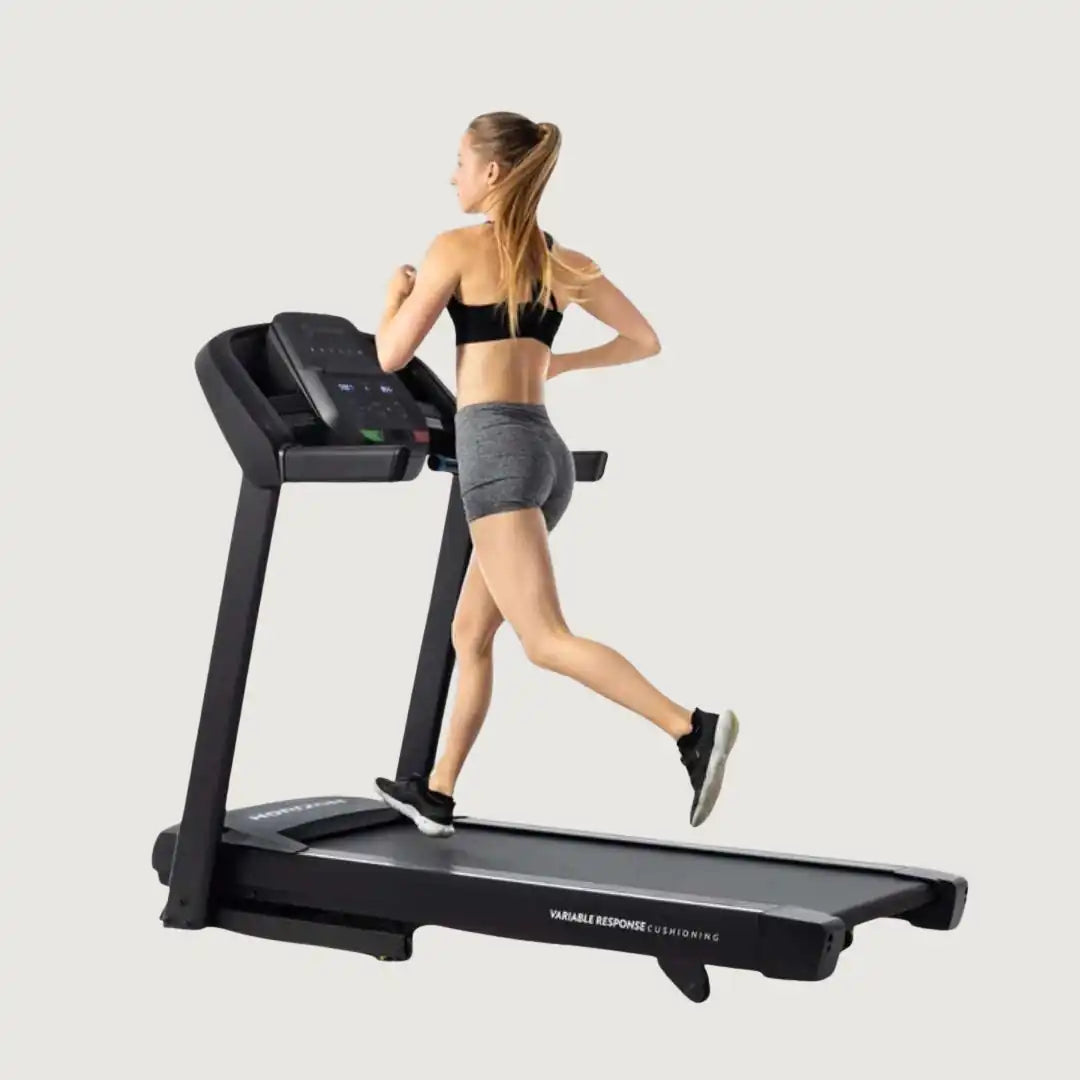 Woman running on the Horizon treadmill wearing workout gear