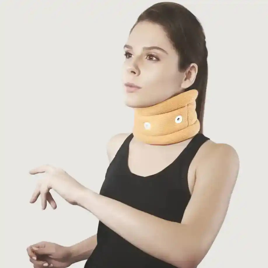 Woman wearing a yellow neck pillow against a plain background