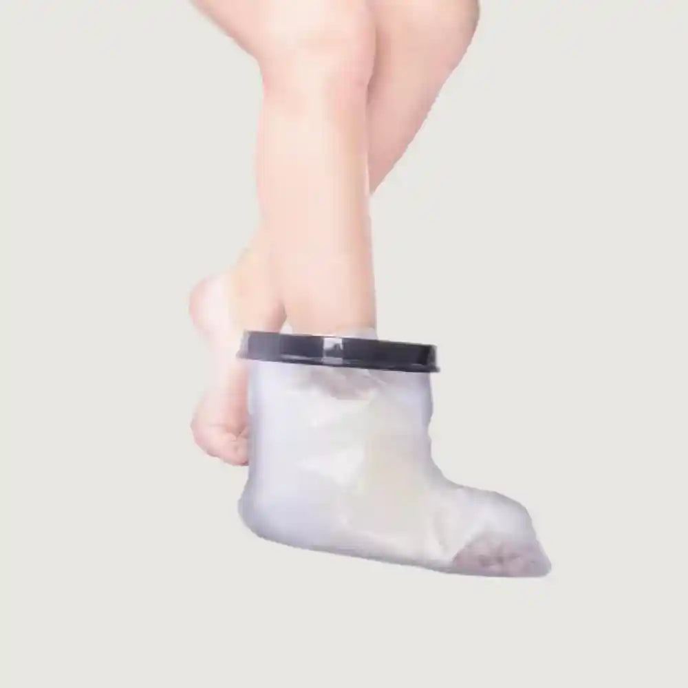 Clear plastic foot coverings with a black lid on a light gray background