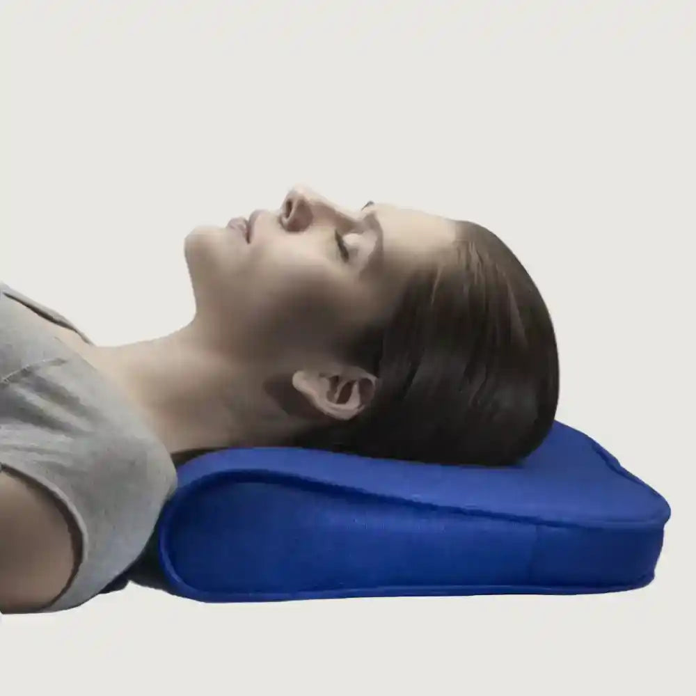 Person lying on a blue wedge pillow against a plain background