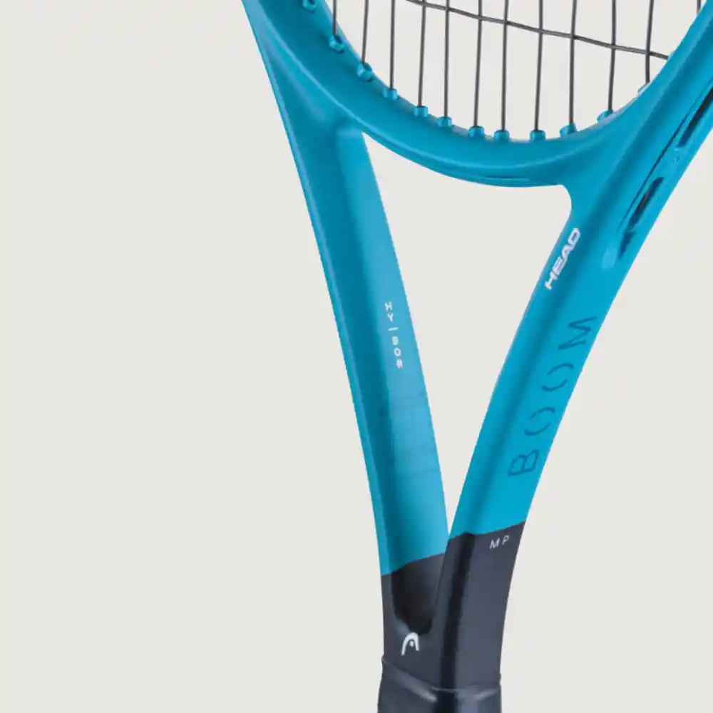Close-up of a tennis racket showing the blue and black HEAD BOOM series 100 racket head and grip against a light gray background.