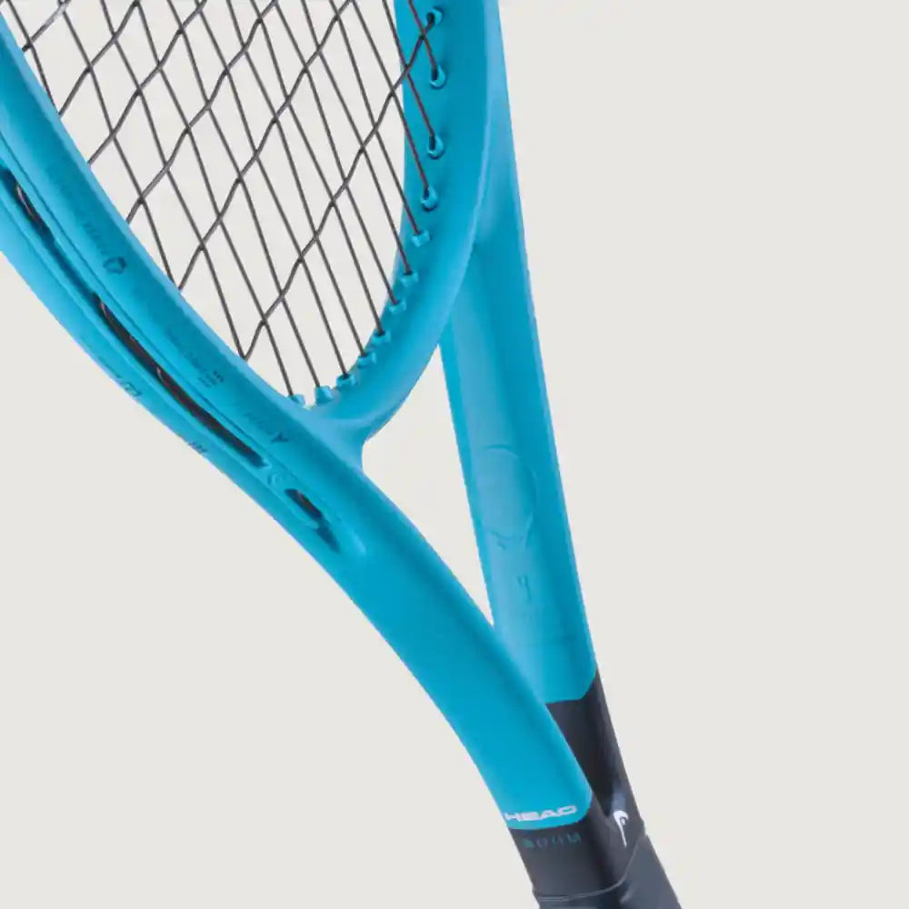 Close-up of a tennis racket showing the blue frame, black strings, and a black grip against a light gray background.