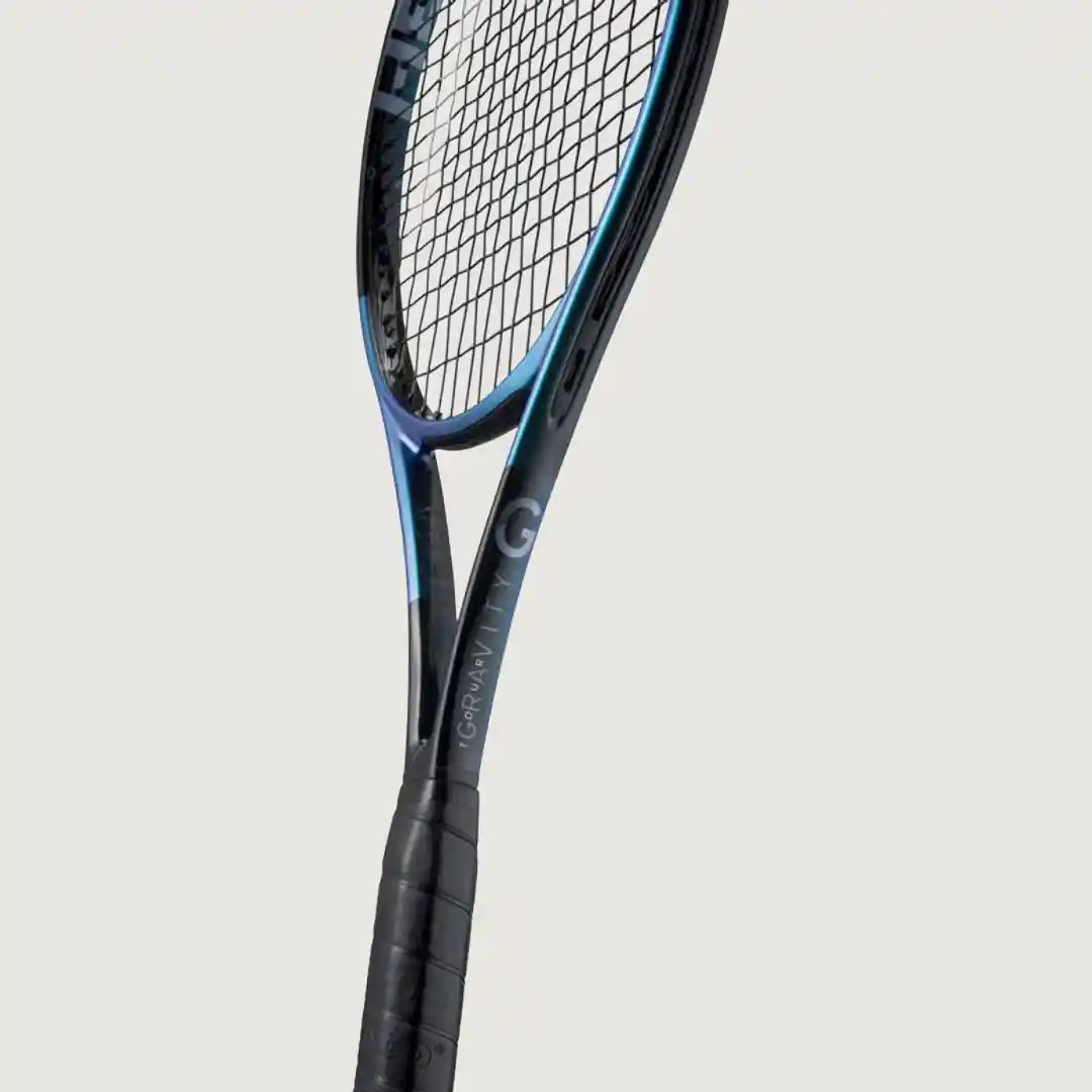 A close-up of a tennis racket showing the upper frame, strings, and part of the grip against a light gray background.
