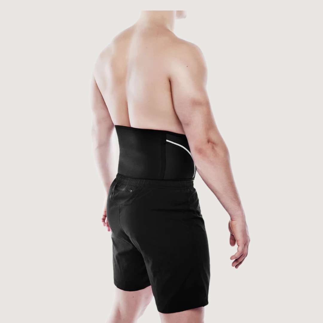 Person wearing a black waist support belt on a plain background