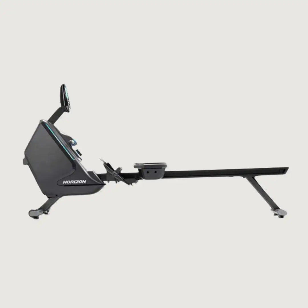 Side view of the Horizon Oxford rower highlighting the rail, flywheel, and foot pedals.